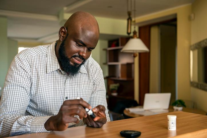 African-Businessman-Doing-Blood-Sugar-Test-at-Home-1193077122_727x484