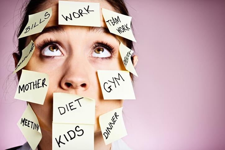 Frustrated-woman-covered-in-stiocky-reminders-rolls-her-eyes-453539161_725x483