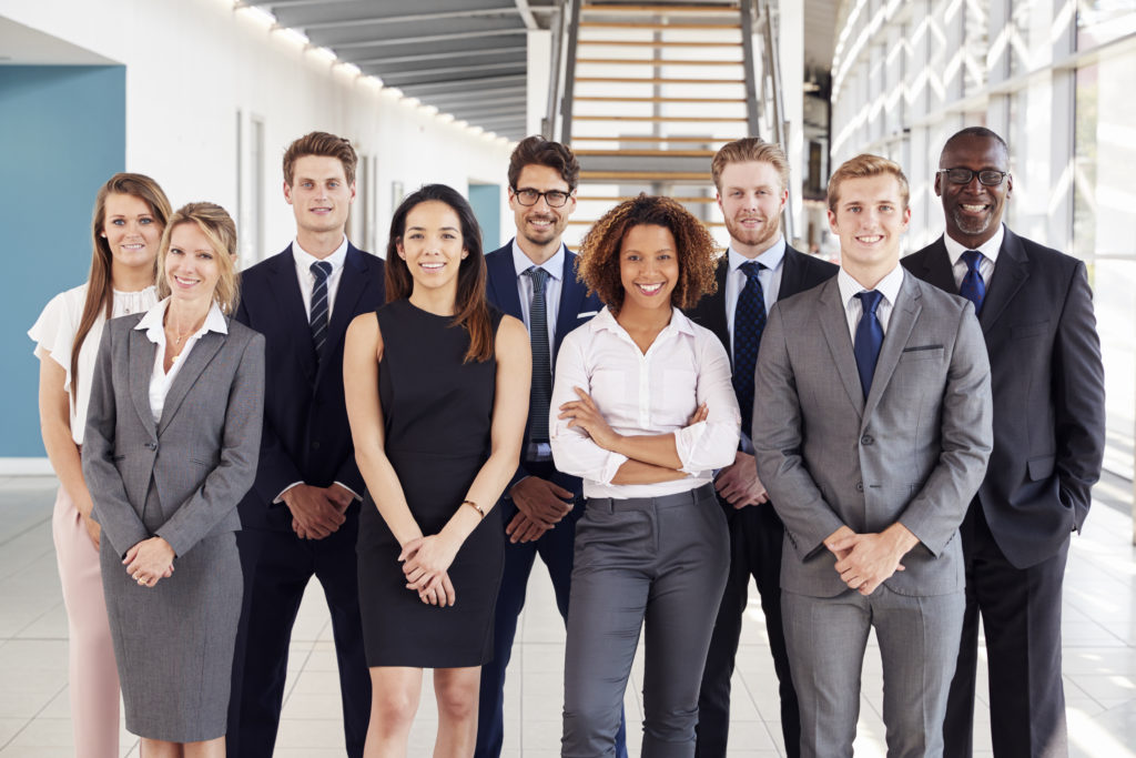 Office workers in a modern lobby, group portrait