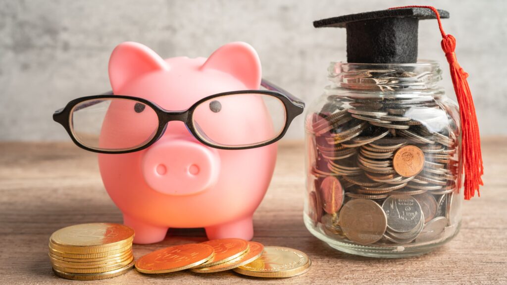 Piggy bank with coins and graduation hat
